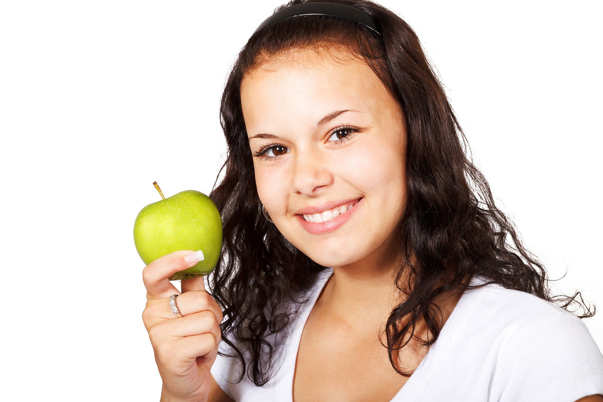 girl smiling holding apple